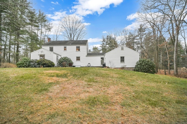 rear view of house with a yard