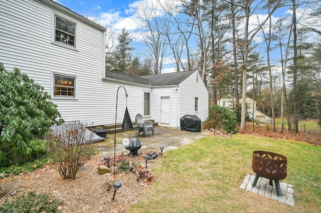 rear view of house featuring a patio area and a lawn