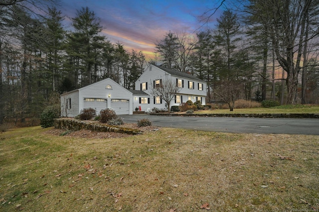 view of front of house with a yard and a garage