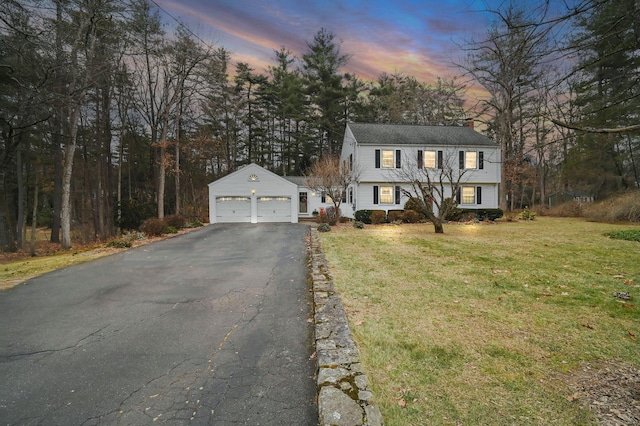 view of front of house featuring a garage and a lawn