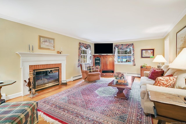 living room with a baseboard radiator, a brick fireplace, hardwood / wood-style flooring, and crown molding