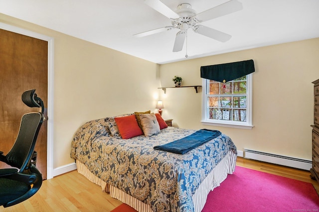 bedroom featuring wood-type flooring, a baseboard radiator, and ceiling fan