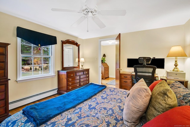 bedroom with ensuite bath, ceiling fan, hardwood / wood-style floors, and a baseboard heating unit