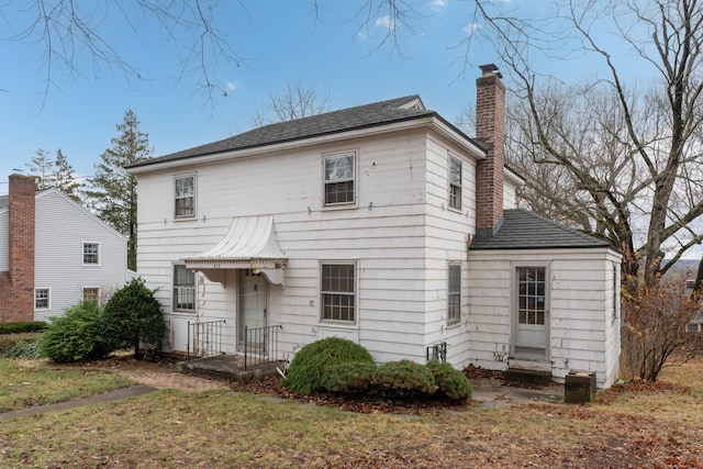 rear view of property with a yard