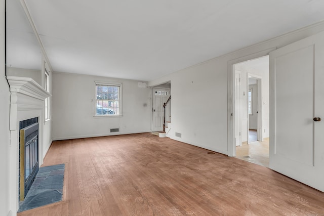 unfurnished living room featuring light hardwood / wood-style flooring