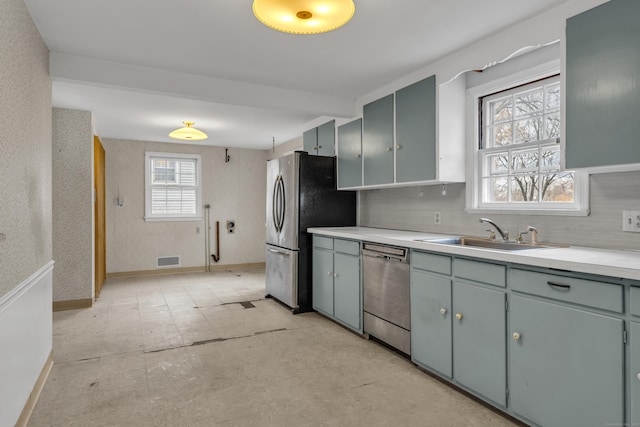 kitchen with stainless steel appliances, tasteful backsplash, and sink