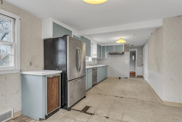 kitchen featuring gray cabinets, a healthy amount of sunlight, sink, and stainless steel appliances