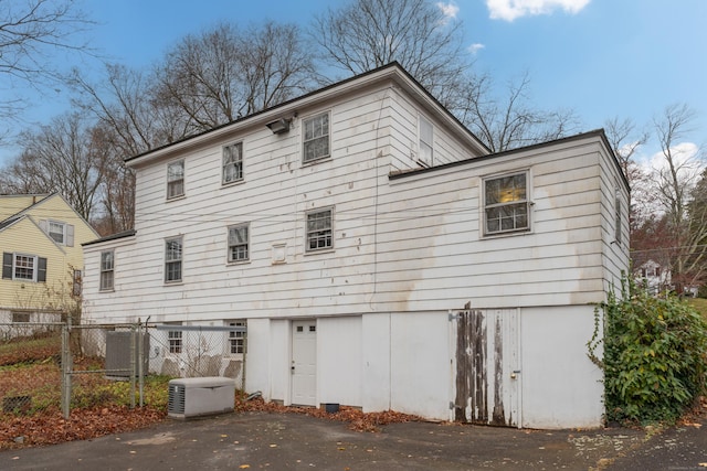 back of house with central AC