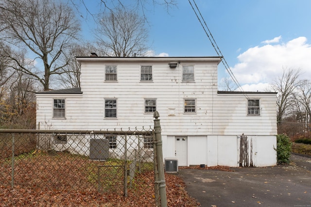 rear view of house featuring cooling unit