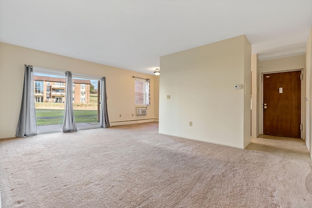 spare room with baseboard heating and light colored carpet