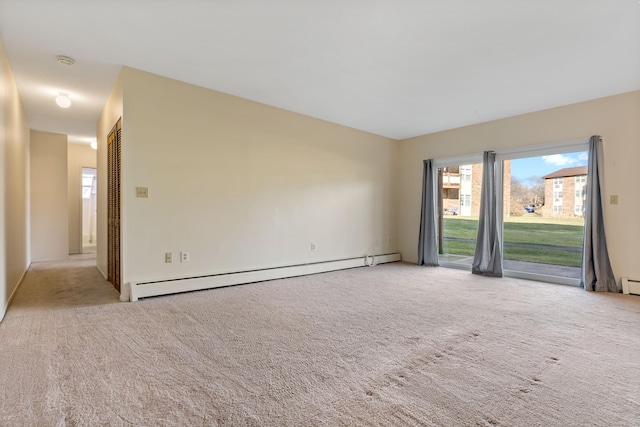 carpeted spare room featuring a baseboard radiator