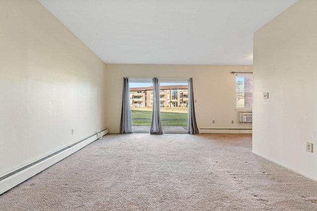 empty room featuring light colored carpet, a wall unit AC, and a baseboard radiator