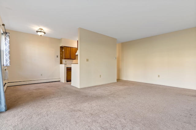 unfurnished living room featuring light carpet and a baseboard heating unit