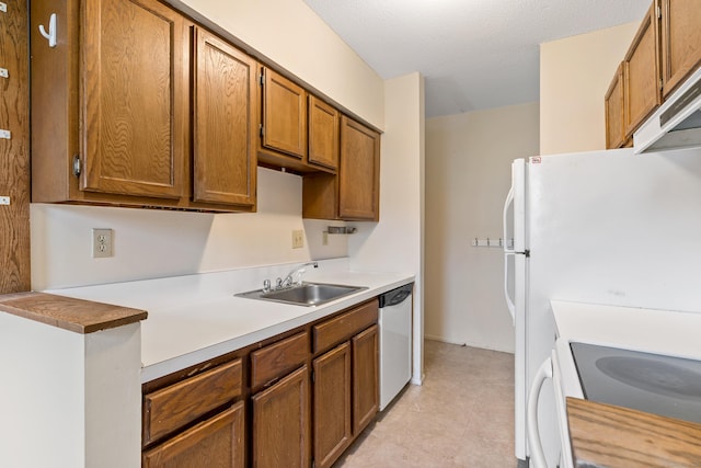 kitchen with exhaust hood, white appliances, a textured ceiling, and sink