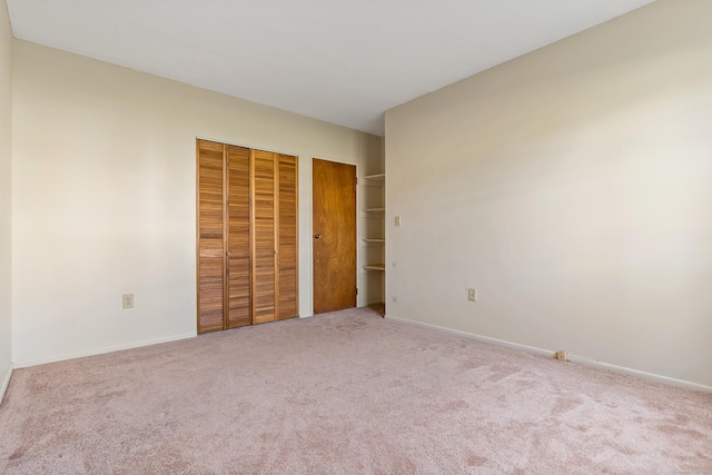 unfurnished bedroom with light colored carpet