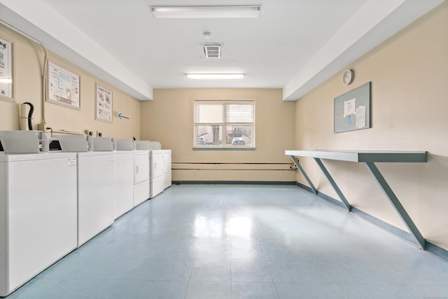 clothes washing area with washing machine and dryer