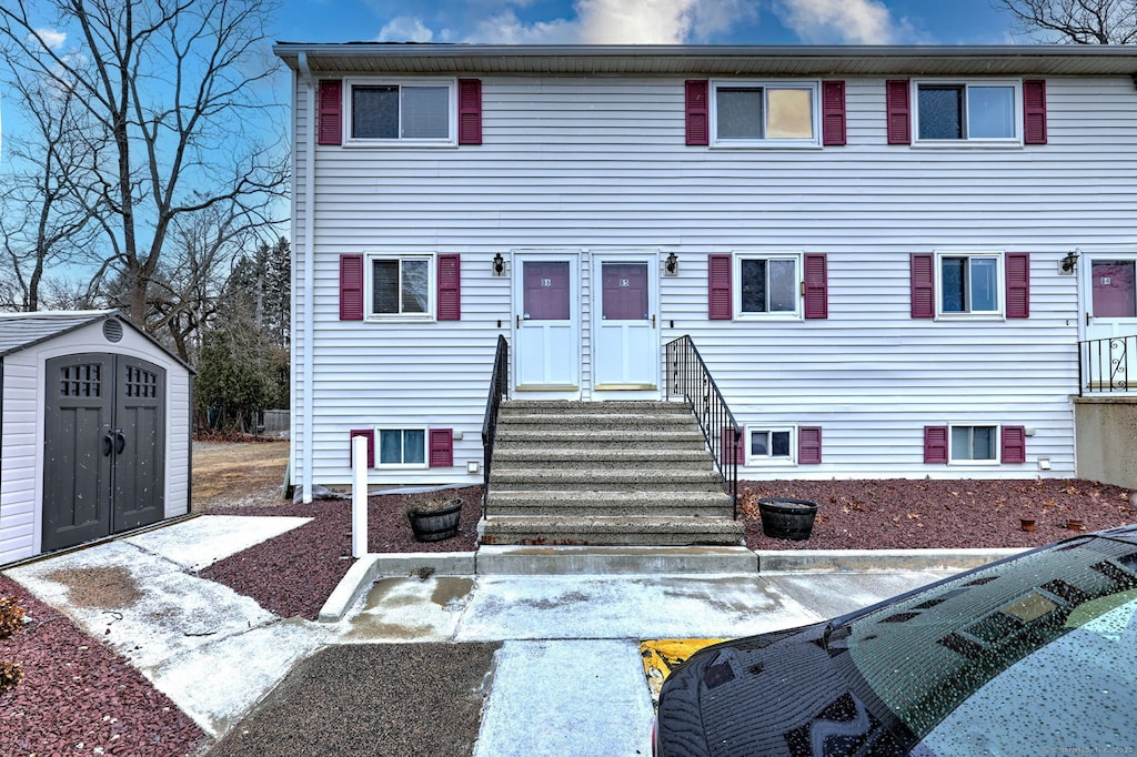 townhome / multi-family property with a shed