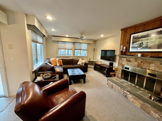 living room with ceiling fan, a fireplace, and light colored carpet