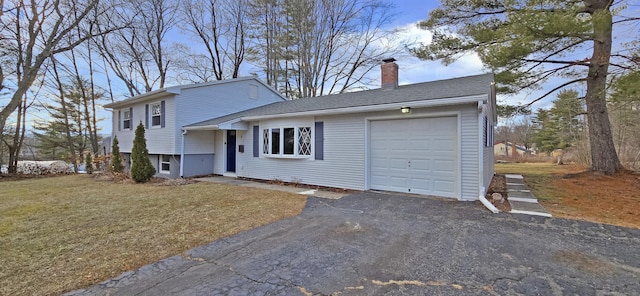 tri-level home with a front lawn and a garage