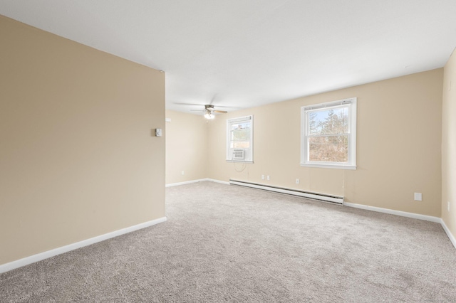 carpeted spare room with ceiling fan and baseboard heating