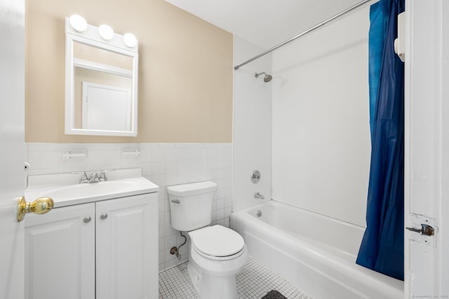 full bathroom with tile patterned flooring, bathtub / shower combination, toilet, vanity, and tile walls