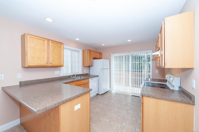 kitchen with kitchen peninsula, light brown cabinetry, white appliances, sink, and light tile patterned floors