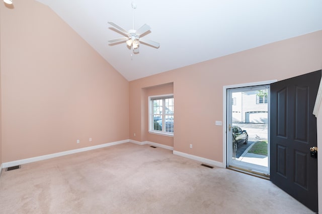 carpeted foyer featuring ceiling fan and vaulted ceiling