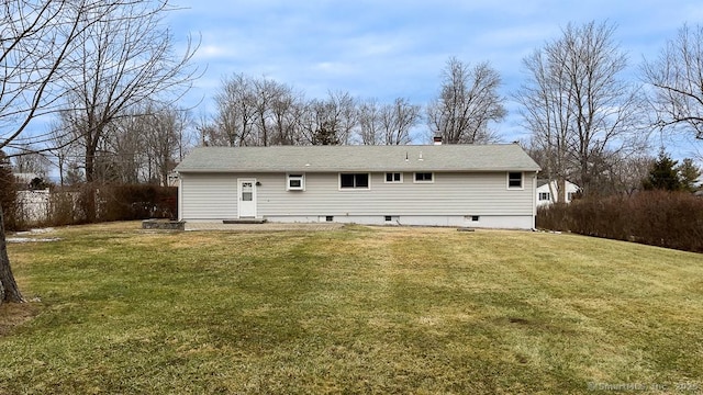 back of property featuring a lawn