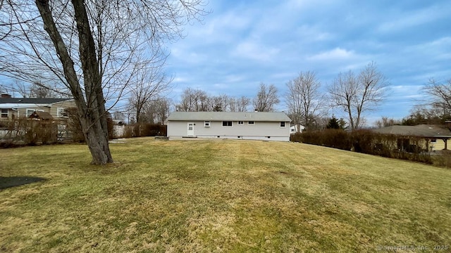 rear view of property featuring a yard