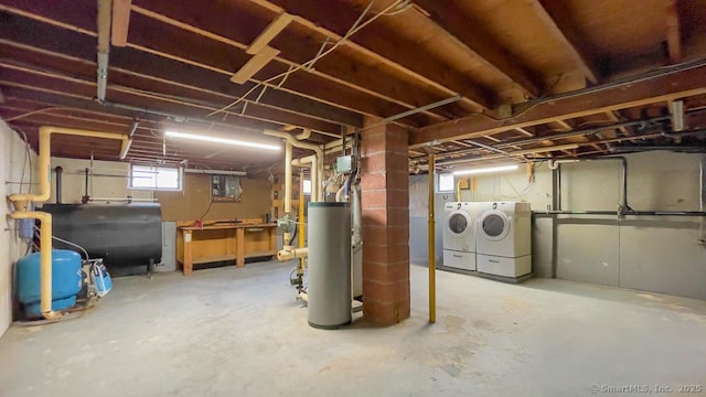 basement with washing machine and dryer and water heater