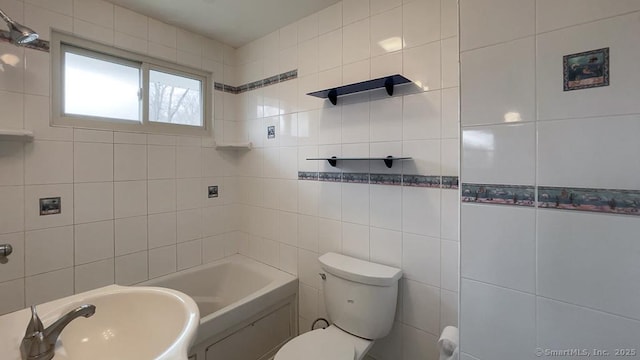 bathroom with toilet, tile walls, and sink