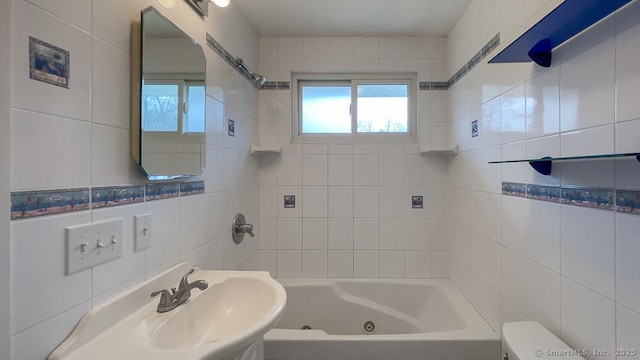 full bathroom with toilet, tiled shower / bath, and sink