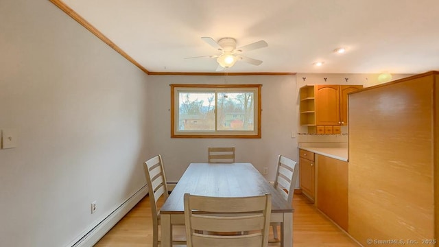 dining area featuring ceiling fan, a baseboard radiator, crown molding, and light hardwood / wood-style floors