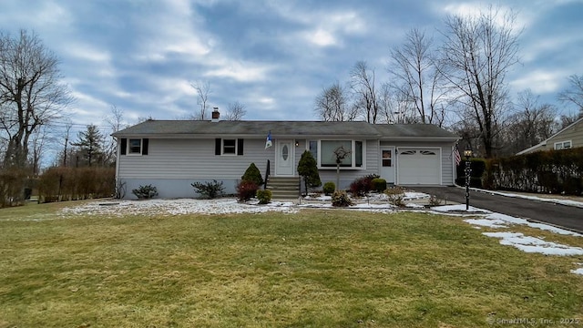 single story home featuring a garage and a front lawn