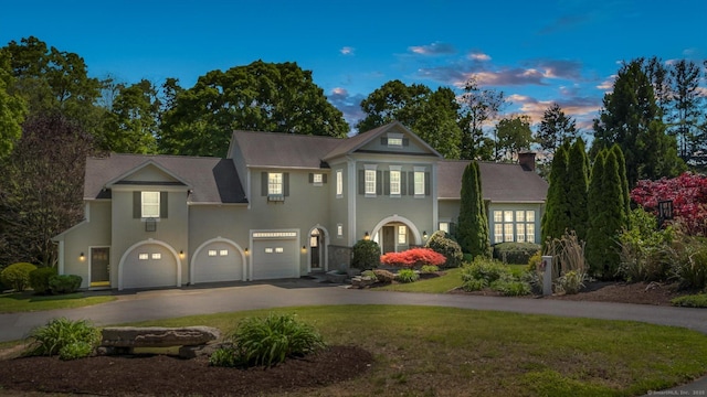 view of front of house with a lawn and a garage