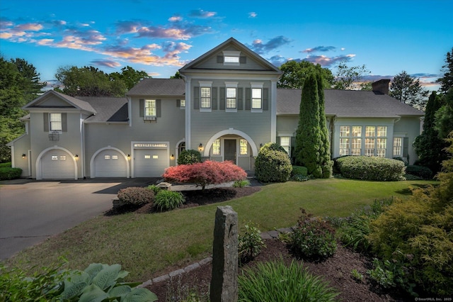 view of front of home featuring a lawn and a garage