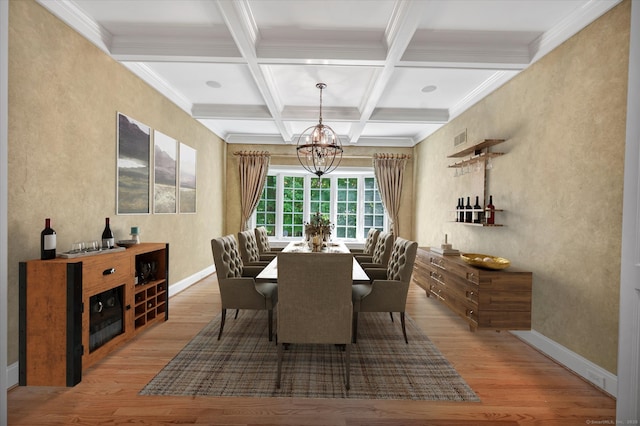 dining area with beam ceiling, hardwood / wood-style flooring, an inviting chandelier, and coffered ceiling