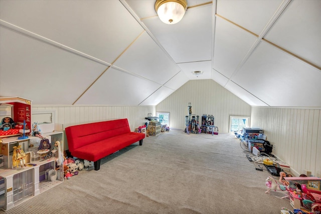 recreation room featuring carpet floors and vaulted ceiling