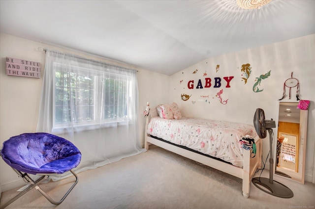 carpeted bedroom with lofted ceiling