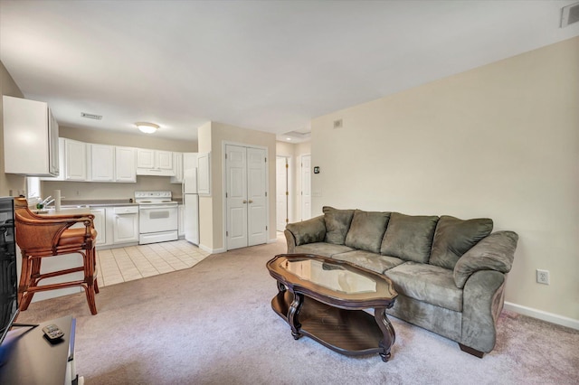 living room featuring light carpet