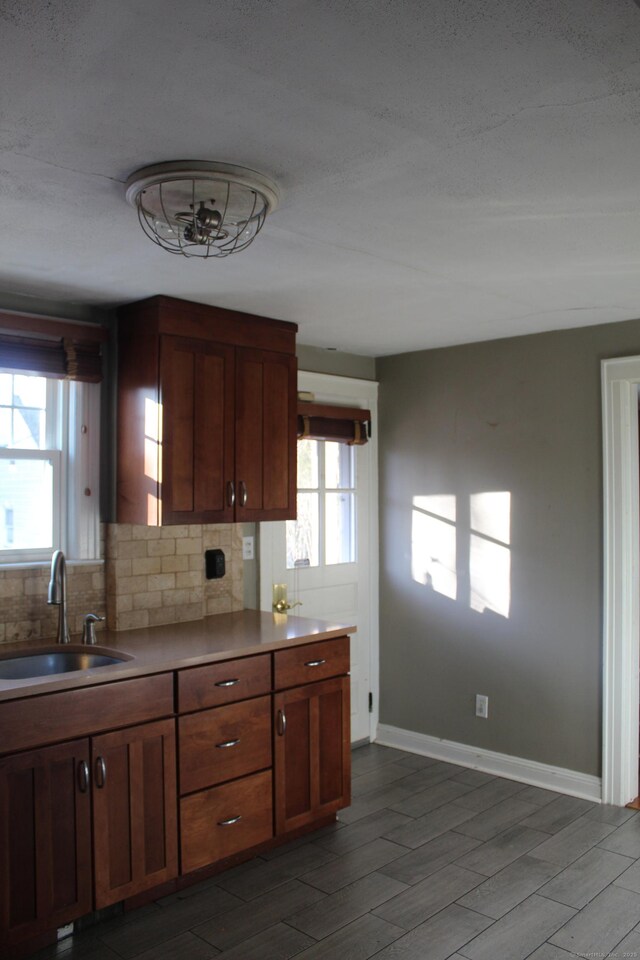 kitchen with a healthy amount of sunlight, decorative backsplash, and sink