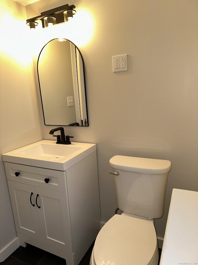 bathroom with vanity, tile patterned floors, and toilet