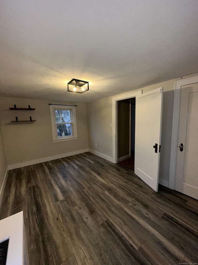 unfurnished room with dark hardwood / wood-style floors