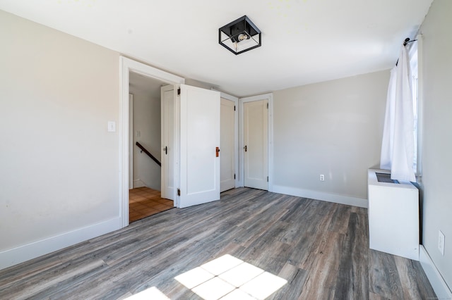 unfurnished bedroom featuring baseboards and wood finished floors