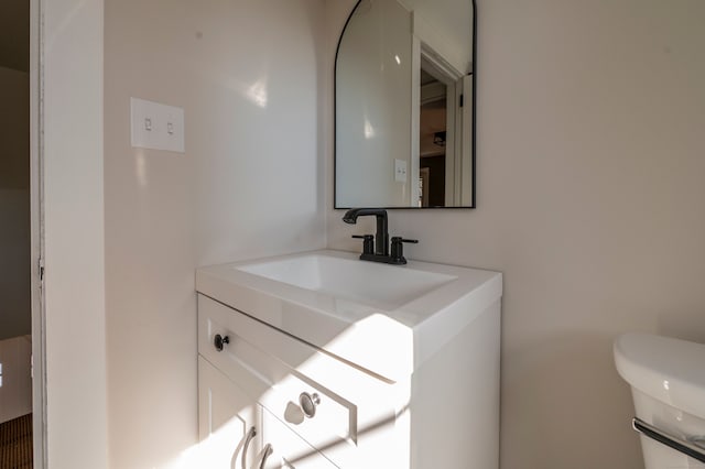 bathroom featuring toilet and vanity