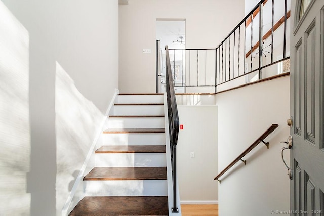 staircase with hardwood / wood-style floors