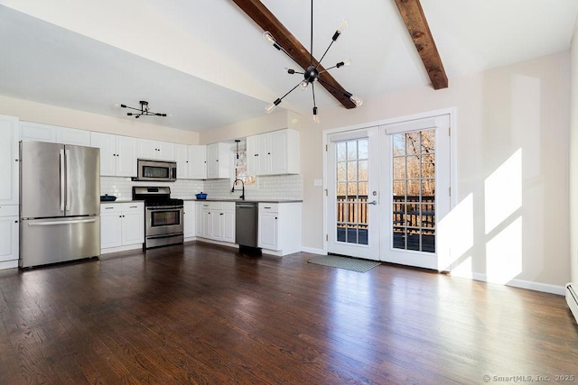 kitchen with french doors, white cabinets, sink, appliances with stainless steel finishes, and dark hardwood / wood-style flooring