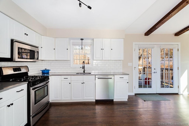 kitchen featuring white cabinetry, sink, french doors, stainless steel appliances, and beamed ceiling