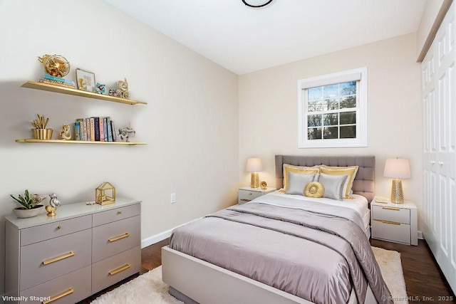 bedroom with dark hardwood / wood-style floors and a closet