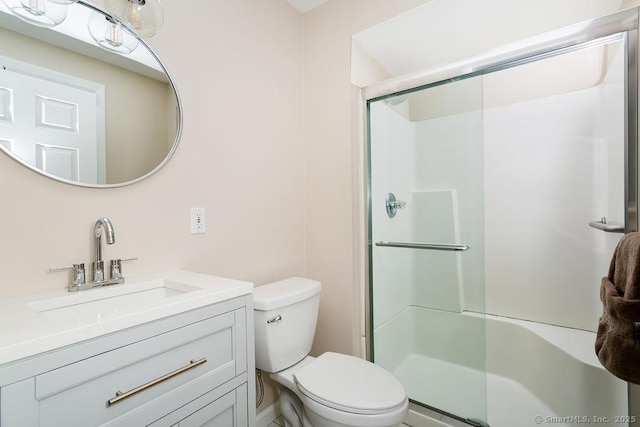 bathroom featuring vanity, toilet, and walk in shower